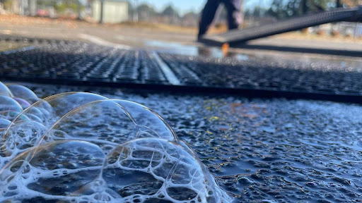 Close-up soap suds during power washing